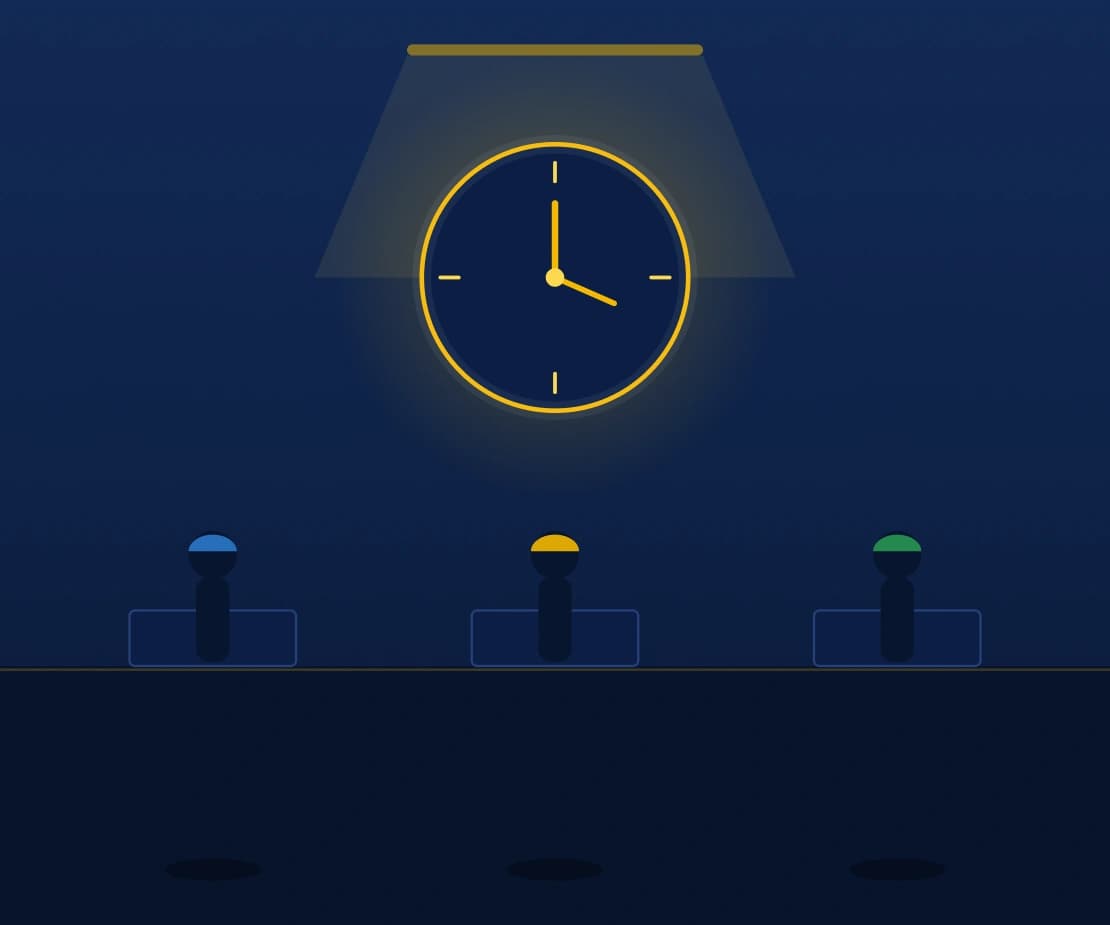 Plant floor time clock with workers clocking in under a spotlight